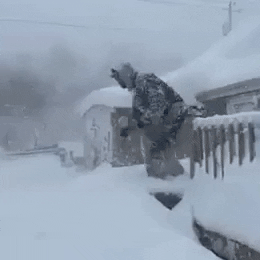Funny Guy Diving In Snow Storm GIF