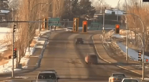 Snowmobile Jumping Over A Road GIF