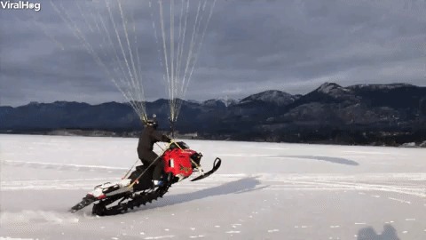 Snowmobile Running With A Parachute GIF