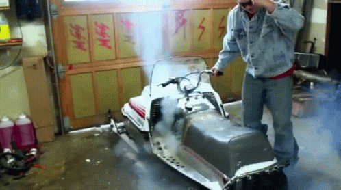 Snowmobile Smoking In A Garage GIF