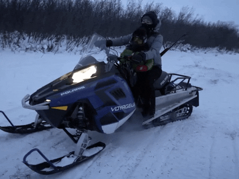 Snowmobile With A Man Taking Off GIF