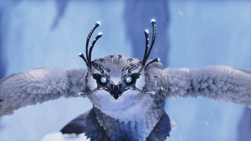 Snowy Owl With Glowing Eyes Flying In Snow GIF