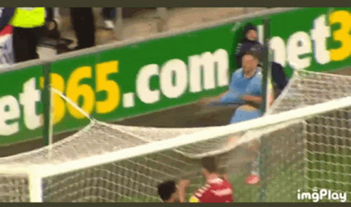 Soccer Game In Front Of Bet65.com Sign GIF