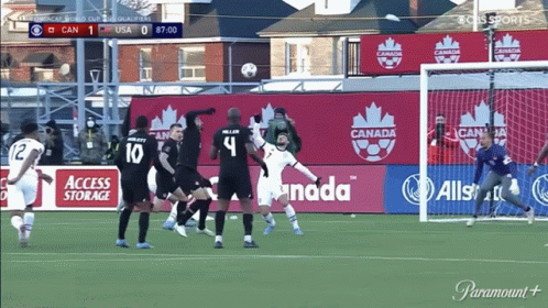 Soccer Game in Front of Canada Sign