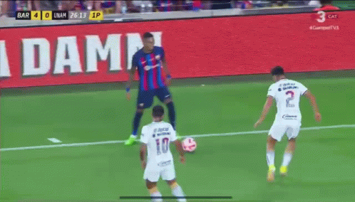 Soccer Game in Front of La Damm Sign