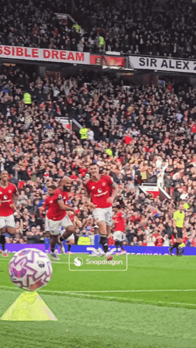 Soccer Game In Front Of Sir Alex Sign