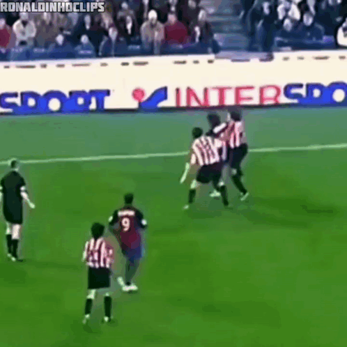 Soccer Game in Front of Sport Interspo Advertisement