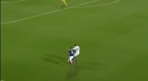 Soccer Game on Field With Palm Advertisements