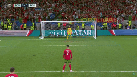 Soccer Game With Visit Qatar Ad Behind Goal
