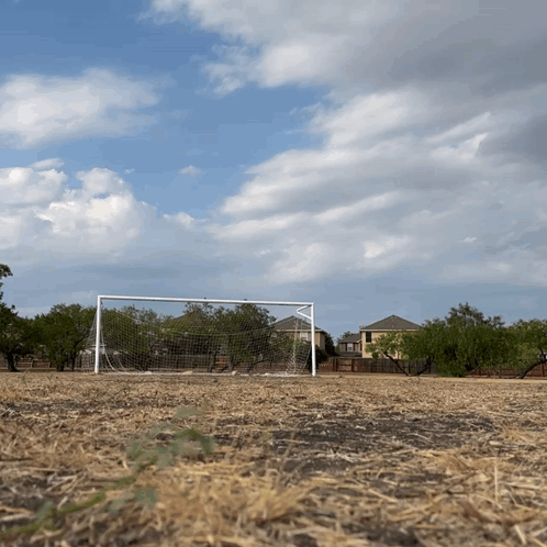 Soccer Goal in Dry Field With House