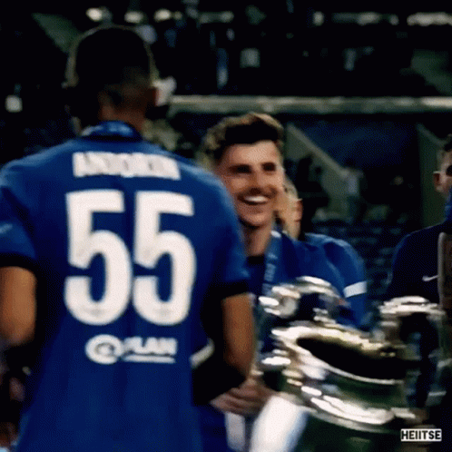 Soccer Player 55 Hugging Teammate With Trophy