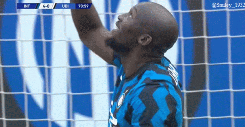 Soccer Player Catching Ball in Blue Black Jersey