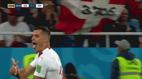 Soccer Player Celebrates Goal Under BBC Banner GIF