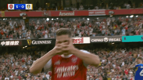 Soccer Player Covering Face In Red Jersey GIF