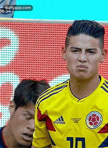 Soccer Player Funny Face Next To Another Player GIF