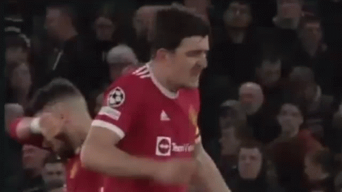 Soccer Player Giving Fist Bump in Front of Crowd