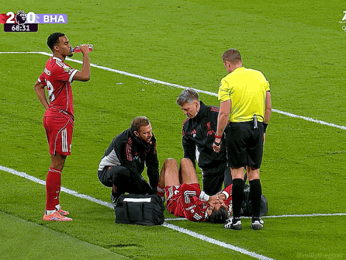 Soccer Player Helped By Doctor And Referee GIF