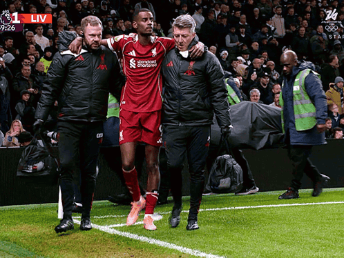 Soccer Player Helped Off By Standard Chartered Man GIF