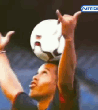 Soccer Player Holding Ball on Head