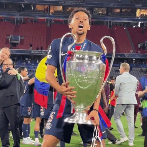 Soccer Player Holding Champions League Trophy