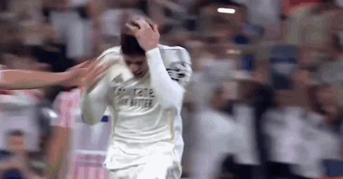 Soccer Player Holding Head in Pain