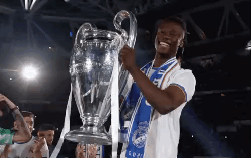 Soccer Player Holding Trophy with Blue Scarf