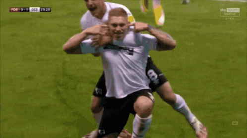 Soccer Player In 32Red Jersey Being Congratulated GIF