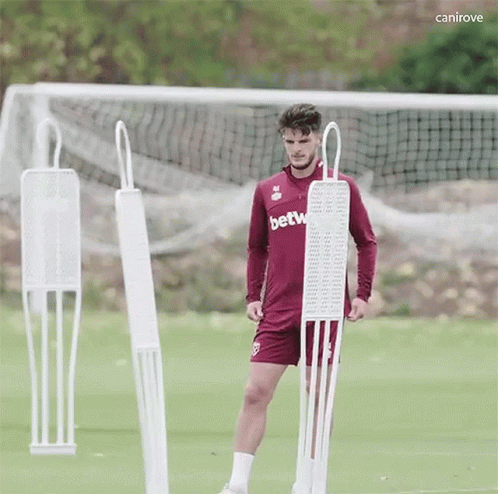 Soccer Player in Betw Jersey Next to Mannequin