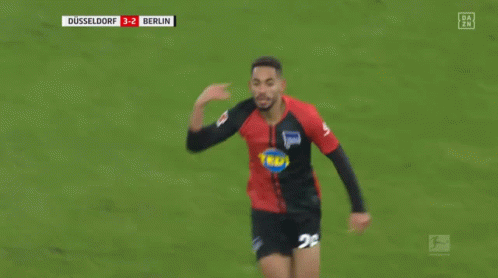 Soccer Player in Black and Red Jersey Running