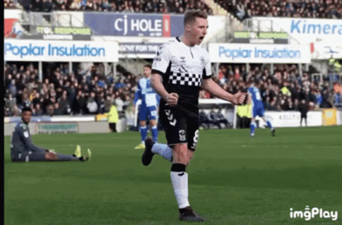 Soccer Player in Black and White Checkered Jersey Celebrating