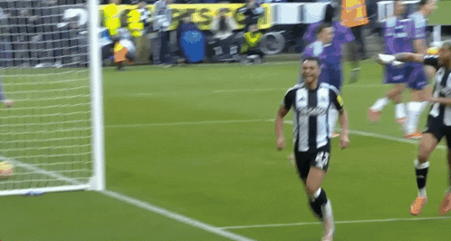 Soccer Player in Black and White Jersey Number 18 Celebrating Goal