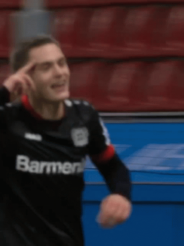 Soccer Player in Black Barmenia Jersey