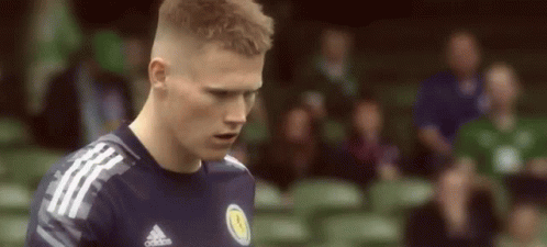 Soccer Player in Blue Adidas Jersey Looking Down