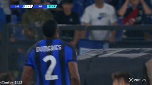 Soccer Player in Blue and Black Jersey Before Scoreboard