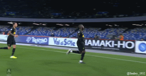Soccer Player in Blue and Black Jersey Catching Ball