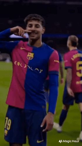 Soccer Player in Blue and Pink Jersey Number 9