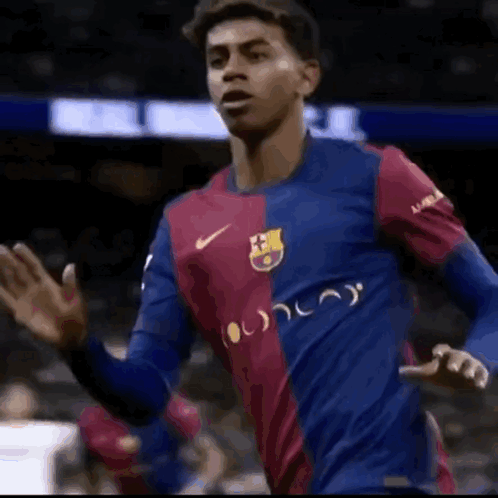 Soccer Player in Blue and Red Nike Jersey Waving
