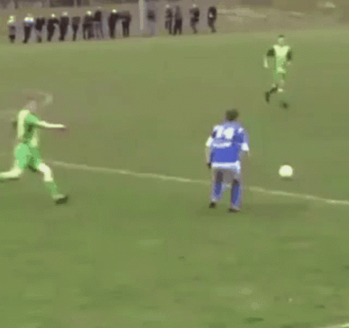 Soccer Player in Blue Jersey Kicking Ball