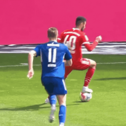 Soccer Player in Blue Jersey Number 11 Kicking Ball