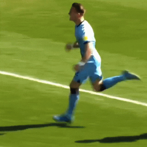 Soccer Player in Blue Jersey Running