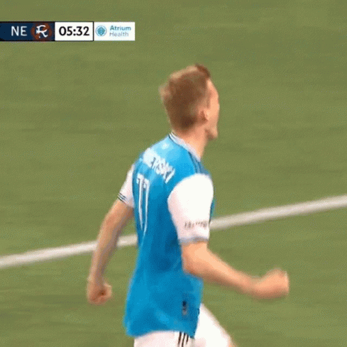 Soccer Player in Blue Jersey With Qatar Tackled