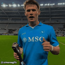 Soccer Player in Blue Msc Shirt Holding Trophy