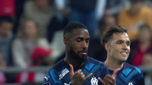 Soccer Player in Blue Shirt Saying Maisons Fortes Thumbs Up