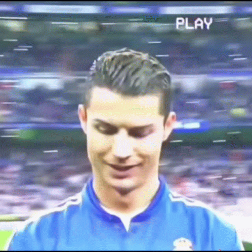 Soccer Player in Blue Shirt Smiling with Play