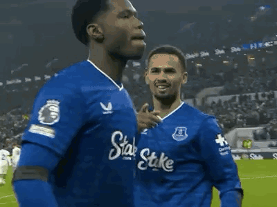 Soccer Player in Blue Shirt With Stake Running