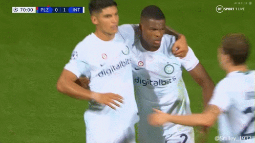 Soccer Player in Digitalbits Jersey Hugging Another Player