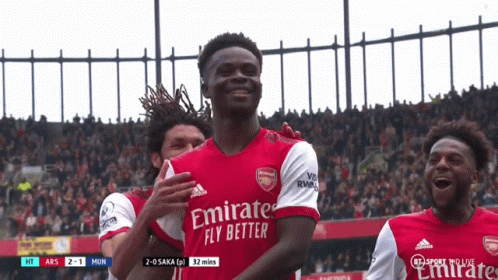 Soccer Player in Emirates Fly Better Jersey Celebrates Goal