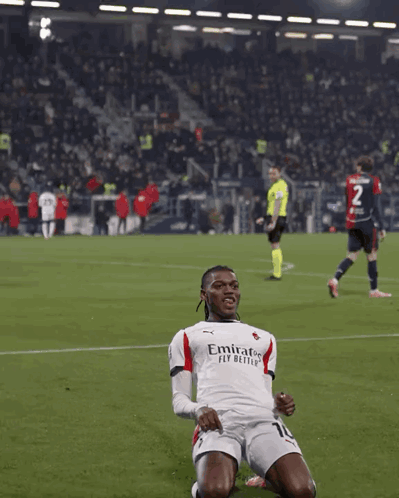 Soccer Player in Emirates Fly Better Jersey Kneeling