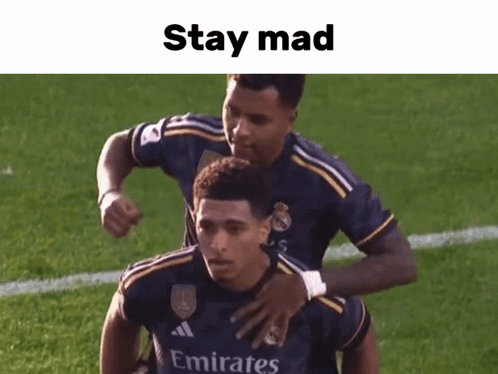 Soccer Player in Emirates Jersey Hugged by Teammate