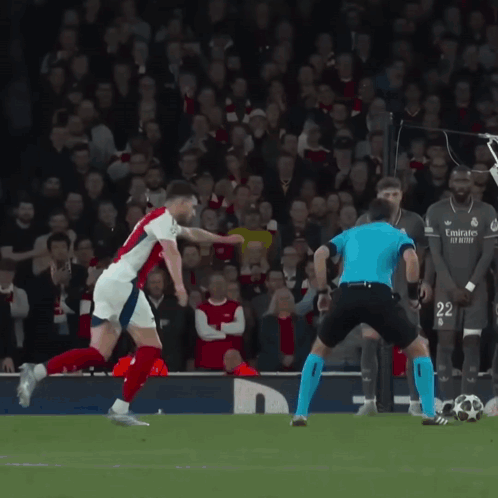 Soccer Player in Emirates Jersey Kicking Ball